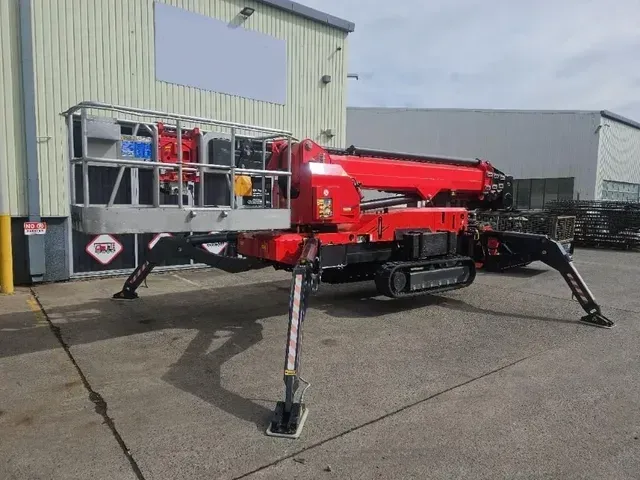 A Red Crane Is Parked in Front of A Building — PEPS Machinery Services In Bethania, QLD