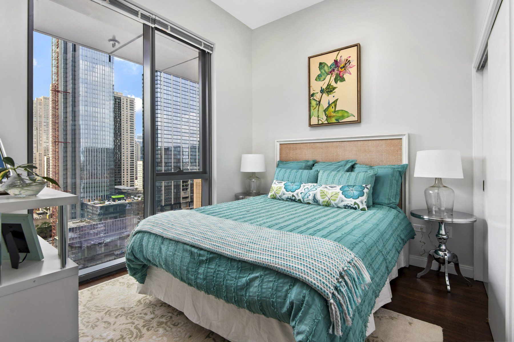 A bedroom with a large bed and a large window at State & Chestnut.