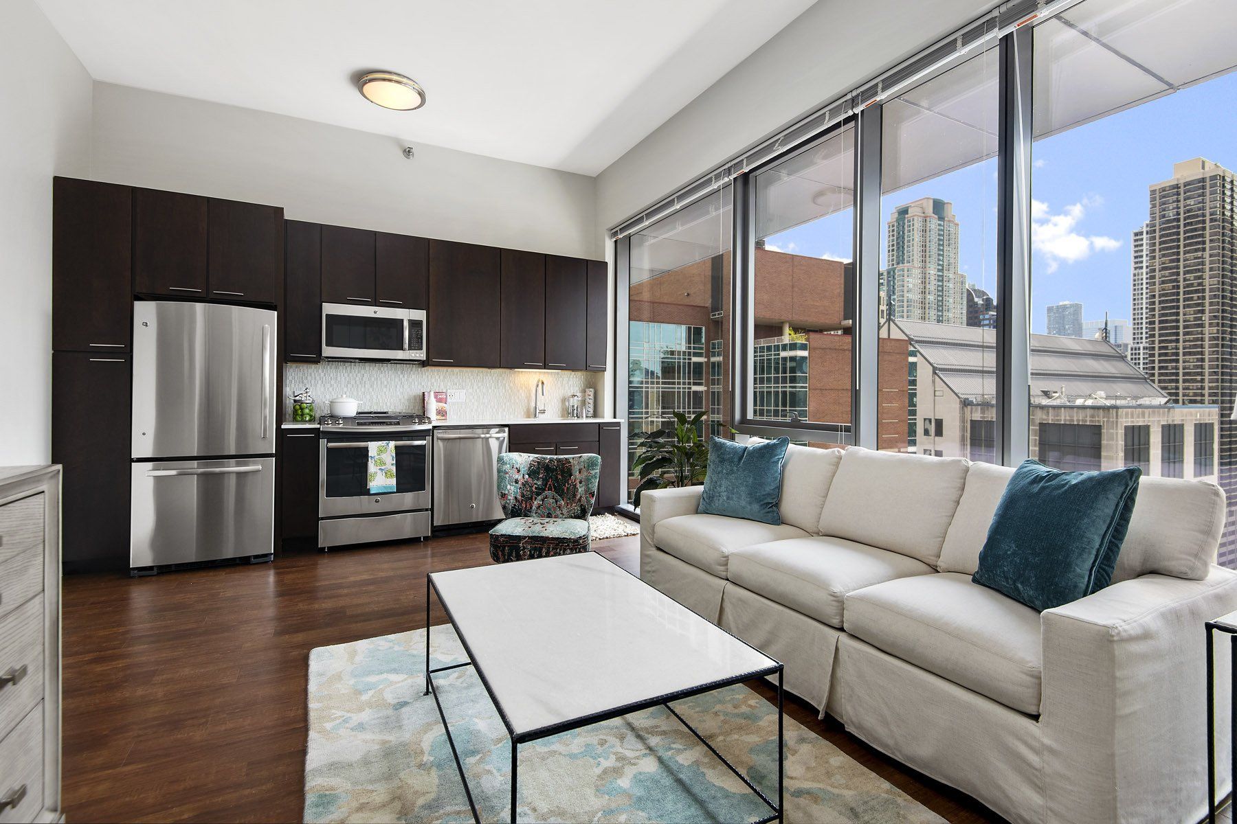 Apartment with white couch and stainless steel kitchen appliances at State & Chestnut