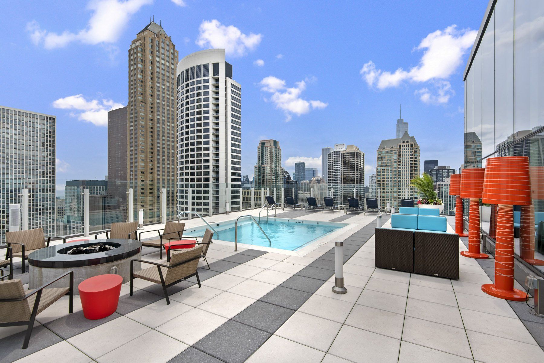 A rooftop patio with a swimming pool and a table and chairs at State & Chestnut.