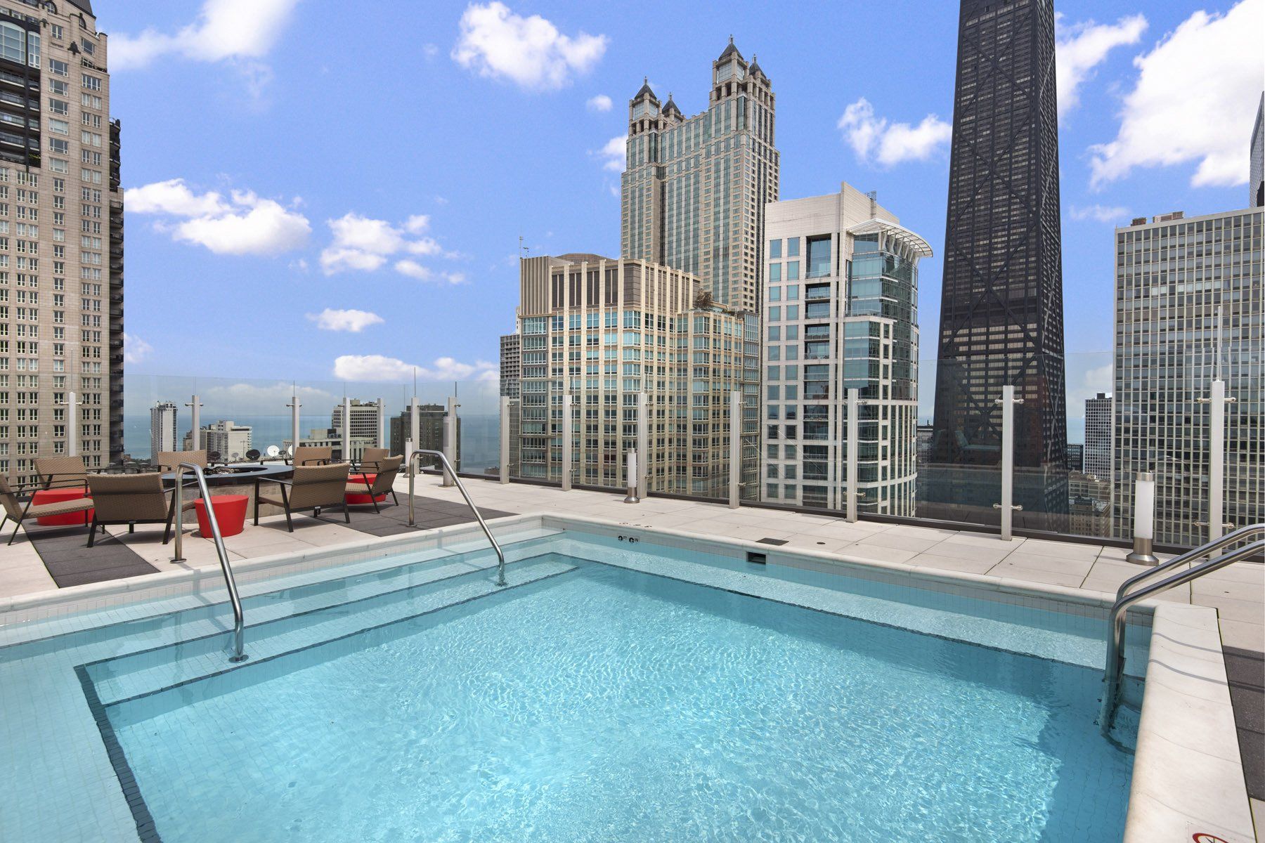 A large swimming pool with a view of a city skyline at State & Chestnut.