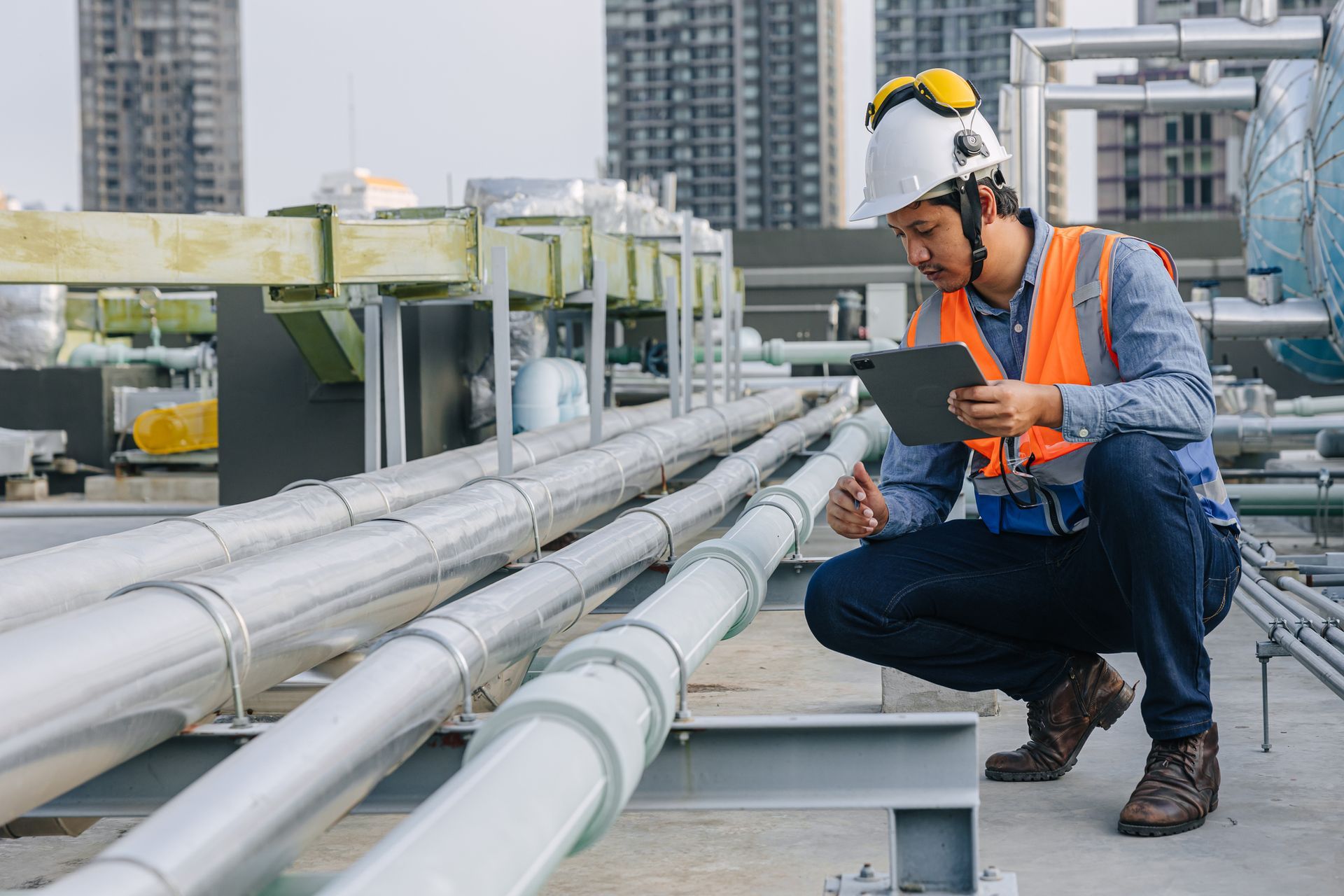 A man is inspecting a water pipe. A man is inspecting a water pipe.