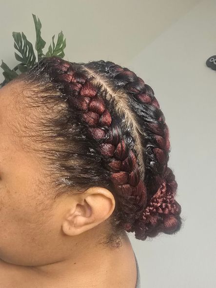 A woman with braids in her hair is wearing a headband.