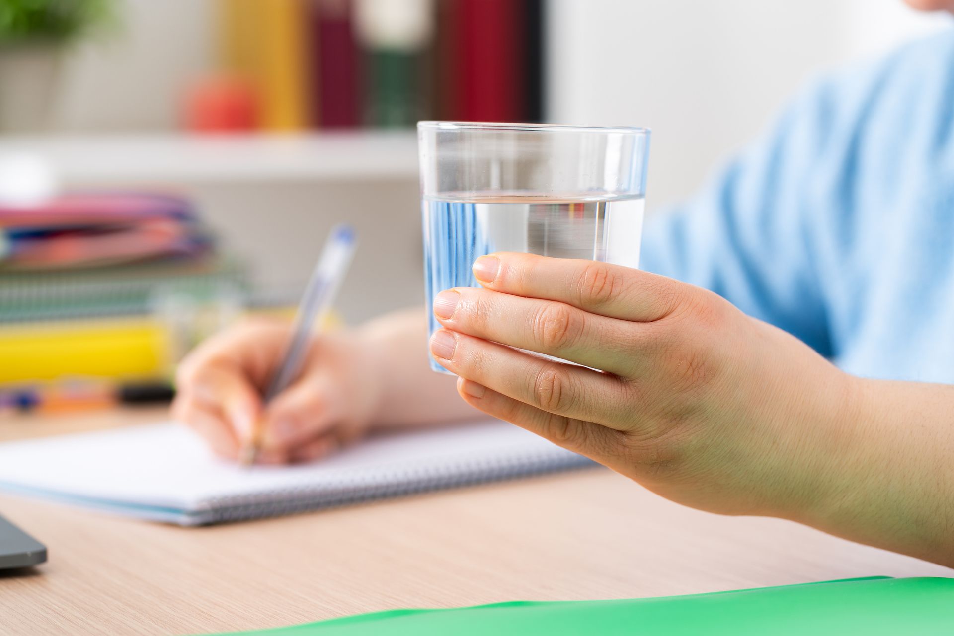 Close up of female hand holding a glass of water providing professional water testing service. Close up of female hand holding a glass of water providing professional water testing service.