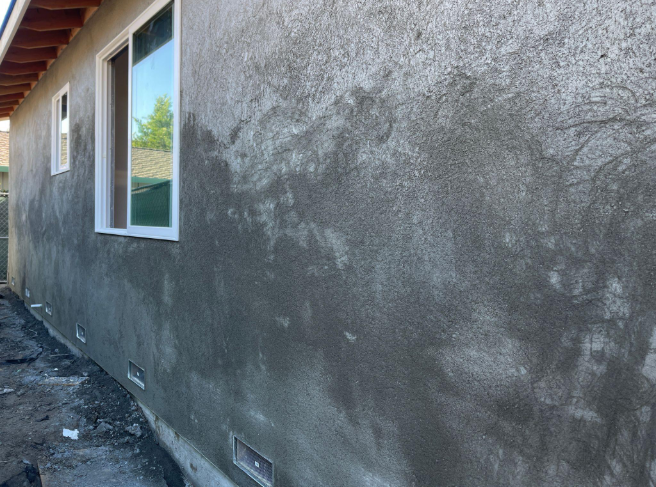 “Side view of a home with a freshly applied gray stucco exterior finish along the wall during a stucco service in Spring Valley, NV”