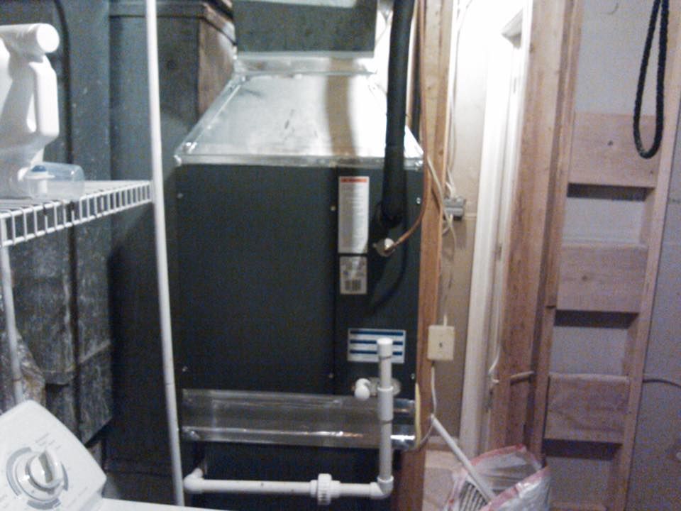 A laundry room with a washer and dryer and an air conditioner