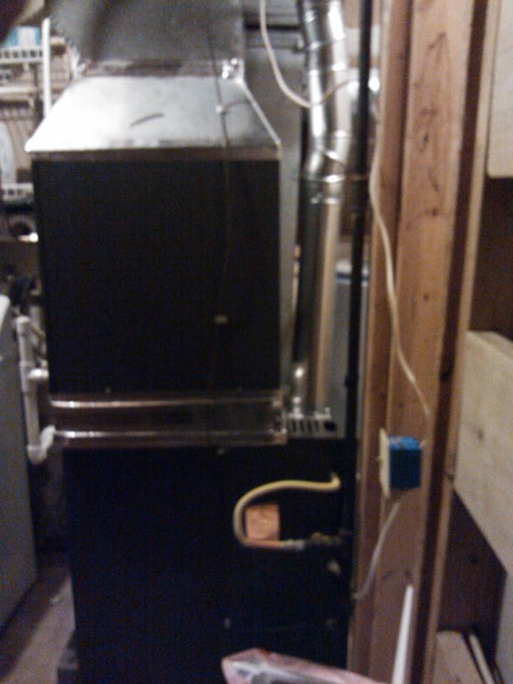 A black stove with a yellow hose attached to it