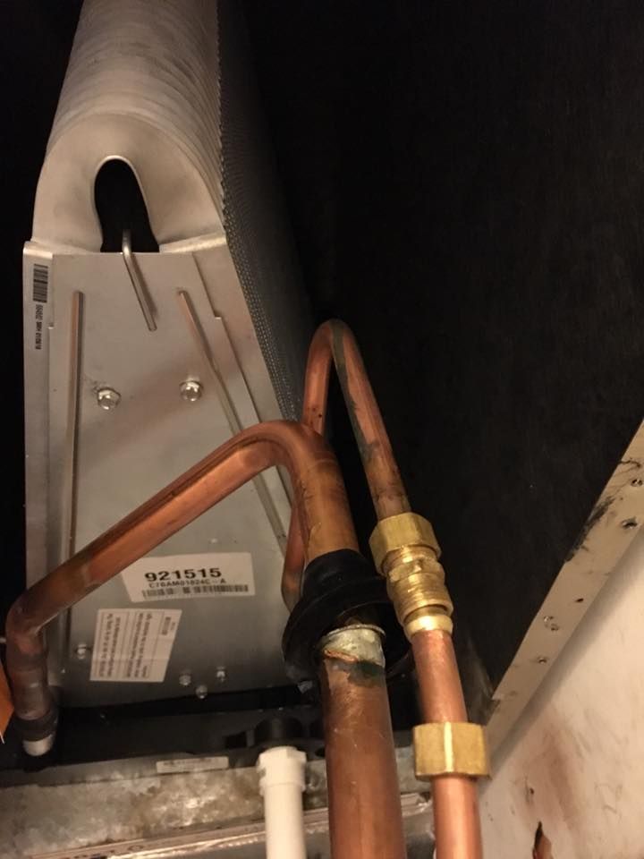 A close up of copper pipes connected to a machine