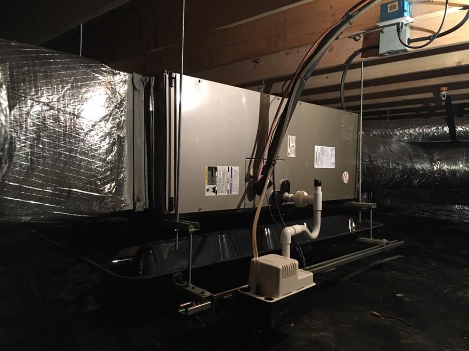 A basement with a lot of pipes and wires