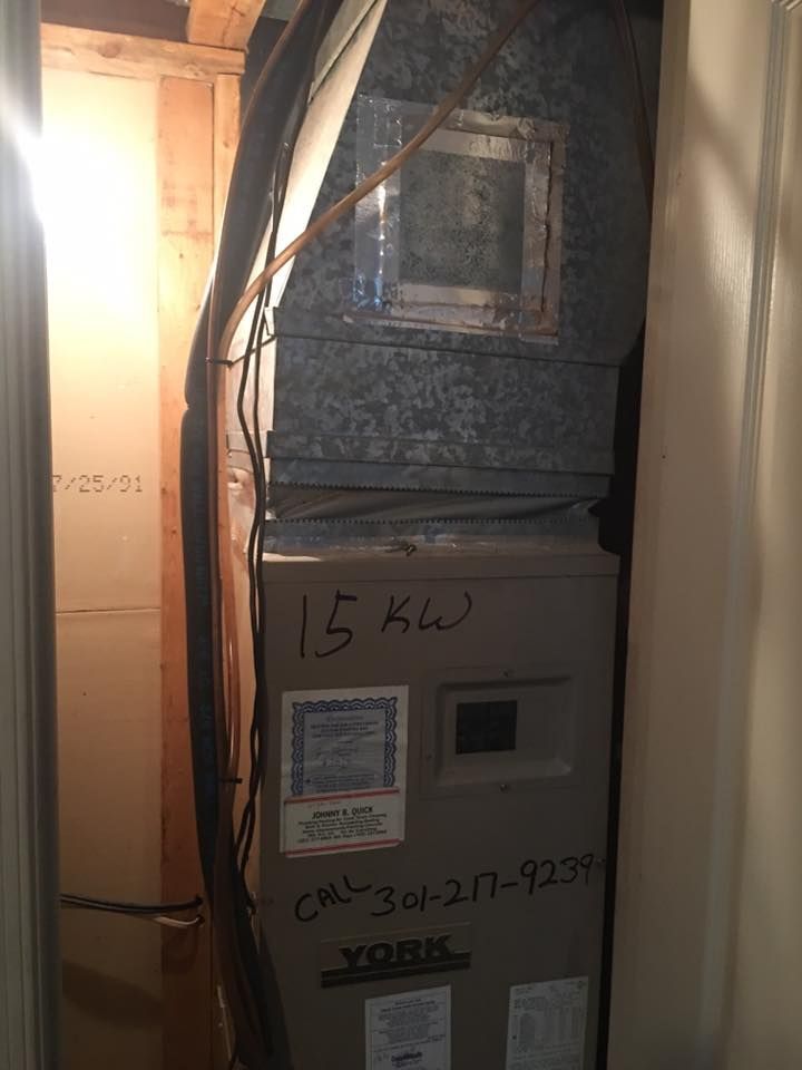 A york air conditioner is sitting in a corner of a room