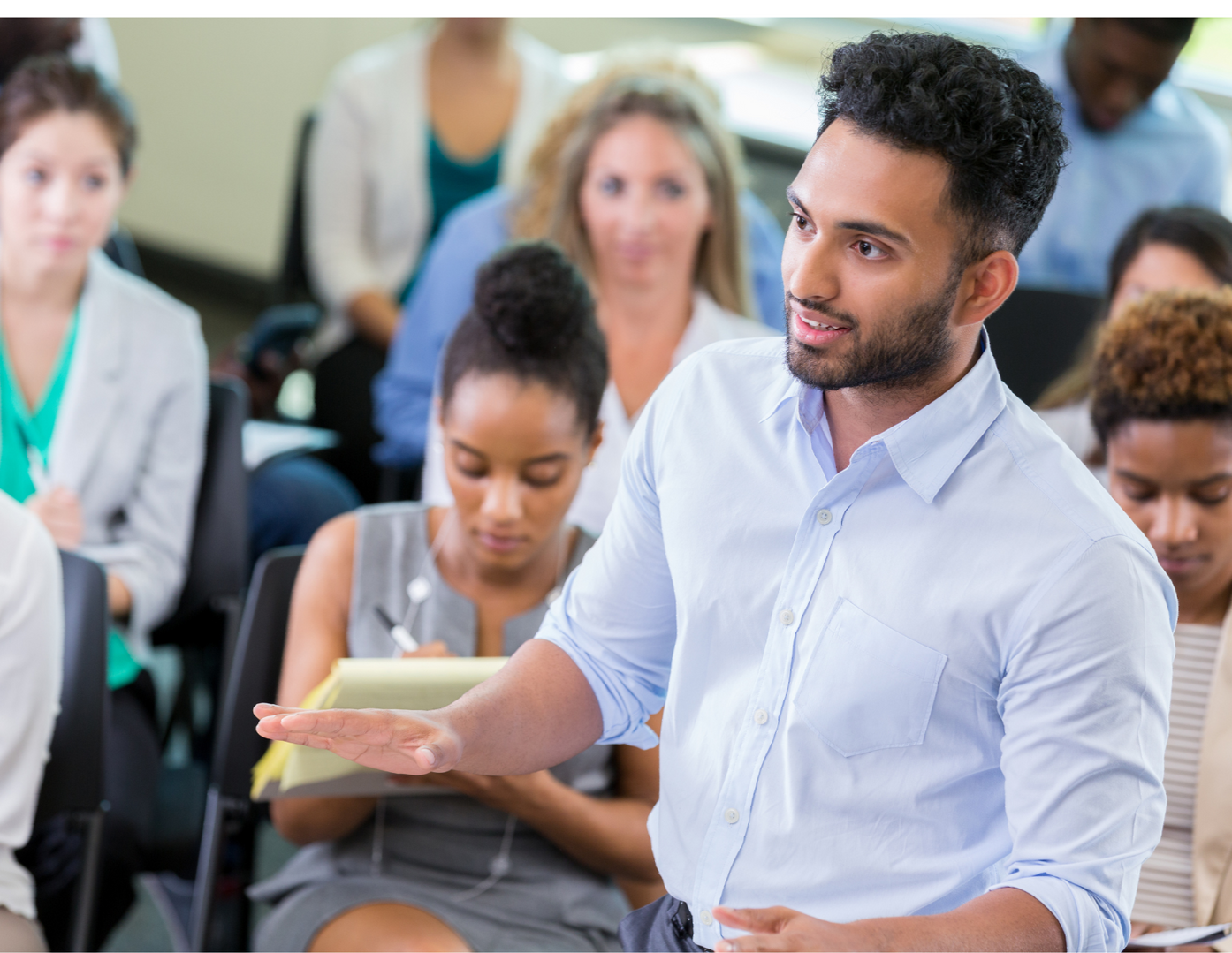 A man is giving a presentation to a group of people.