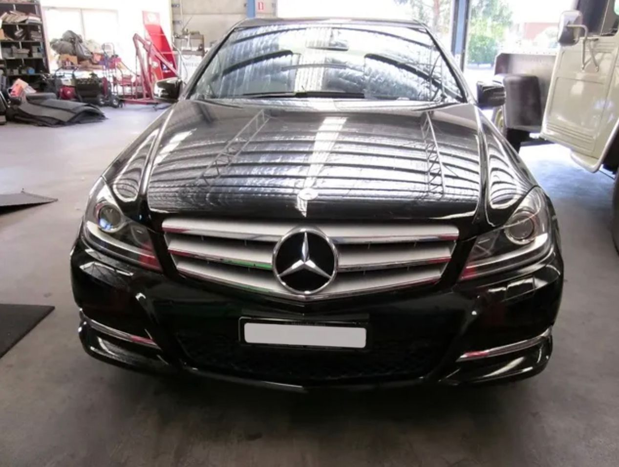 A Black Mercedes is Parked in a Garage — Raff's Advanced Automotive P/L in Fairy Meadow, NSW