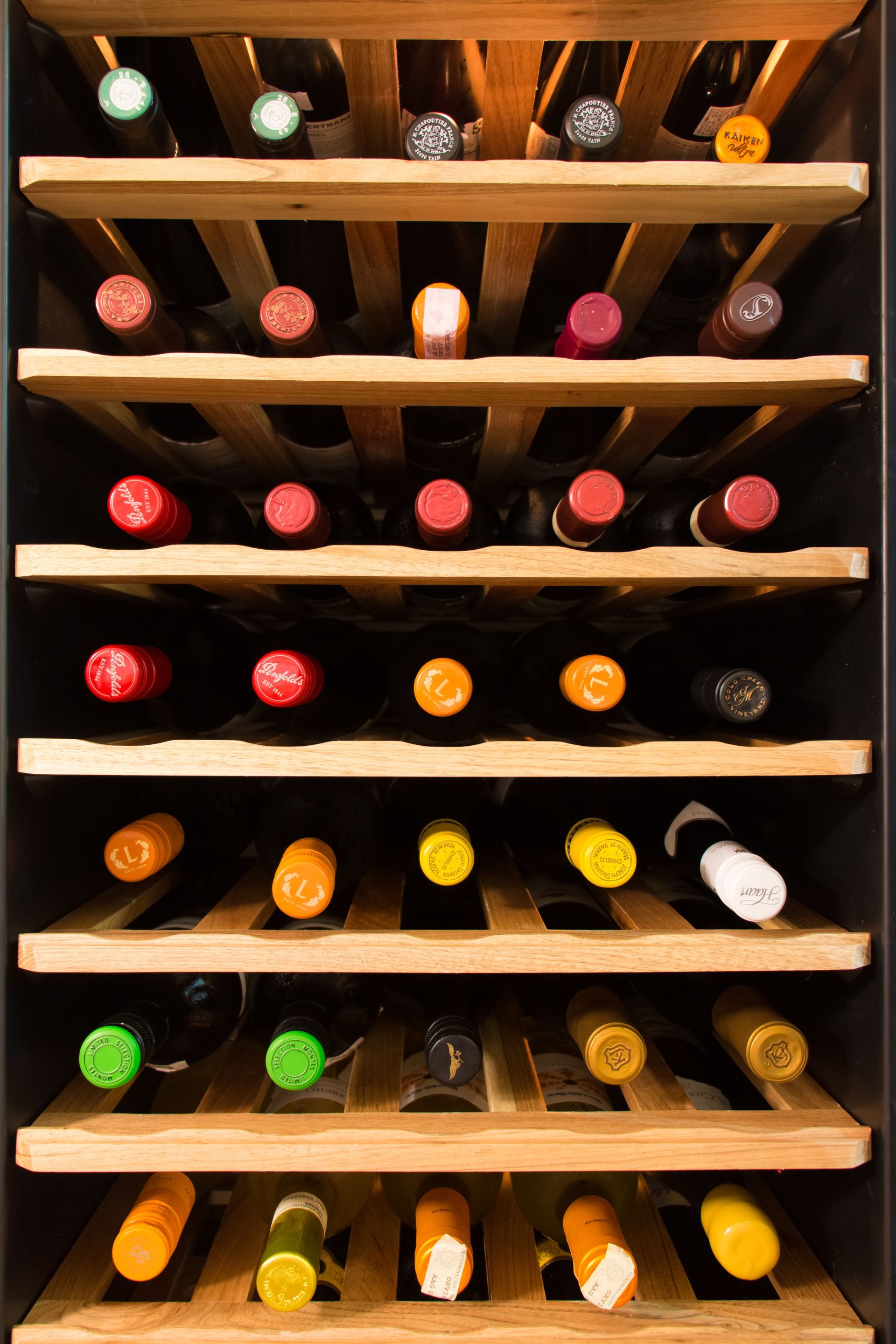 An elegant wine cooler filled with an assortment of exquisite wine bottles.