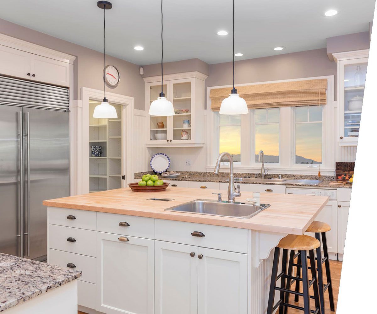 Amazing Luxury Kitchen Interior in white with wooden floor and kitchen island.