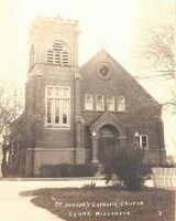 Sepia photo of a stone church with arched entrance and bell tower, labeled “St. Joseph’s Catholic Church, Lyerly, Georgia.”