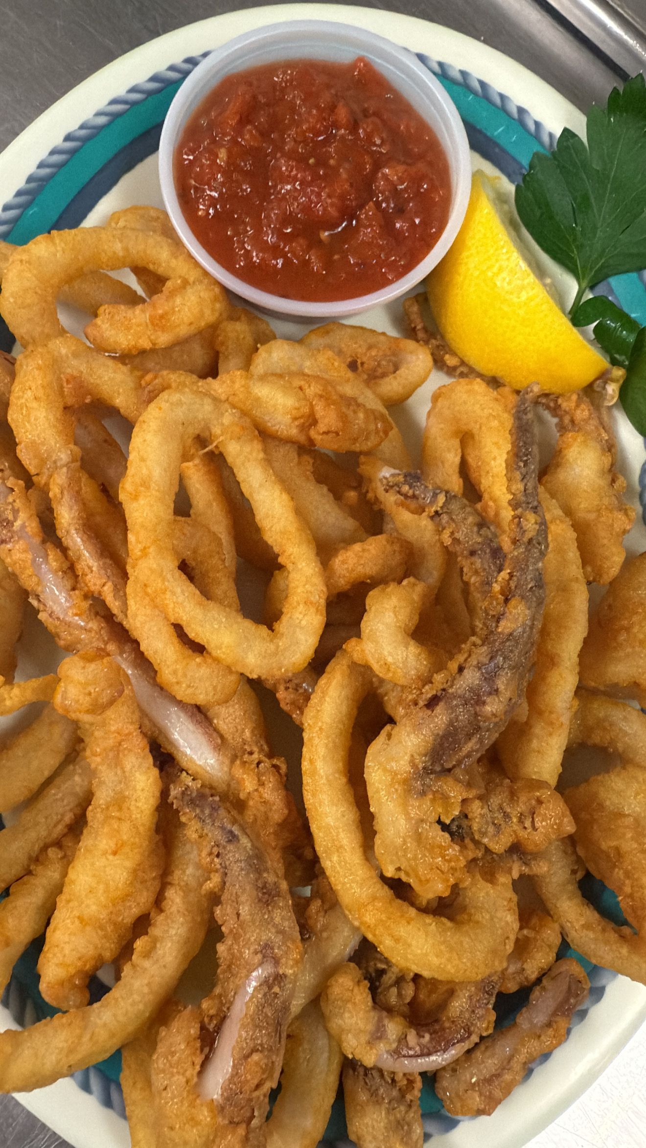 Fried calamari with marinara sauce and a lemon wedge. At High Tide Harry's