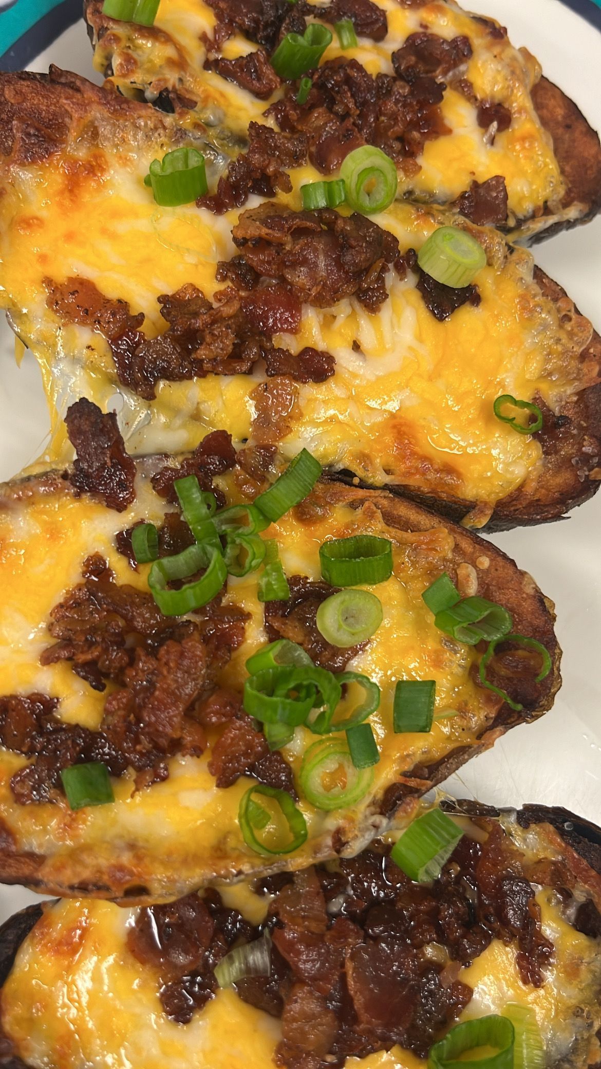 Loaded potato skins with melted cheese, bacon, and green onions. At High Tide Harry's