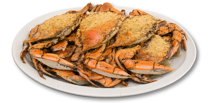 Plate of steamed blue crabs, seasoned with spices.