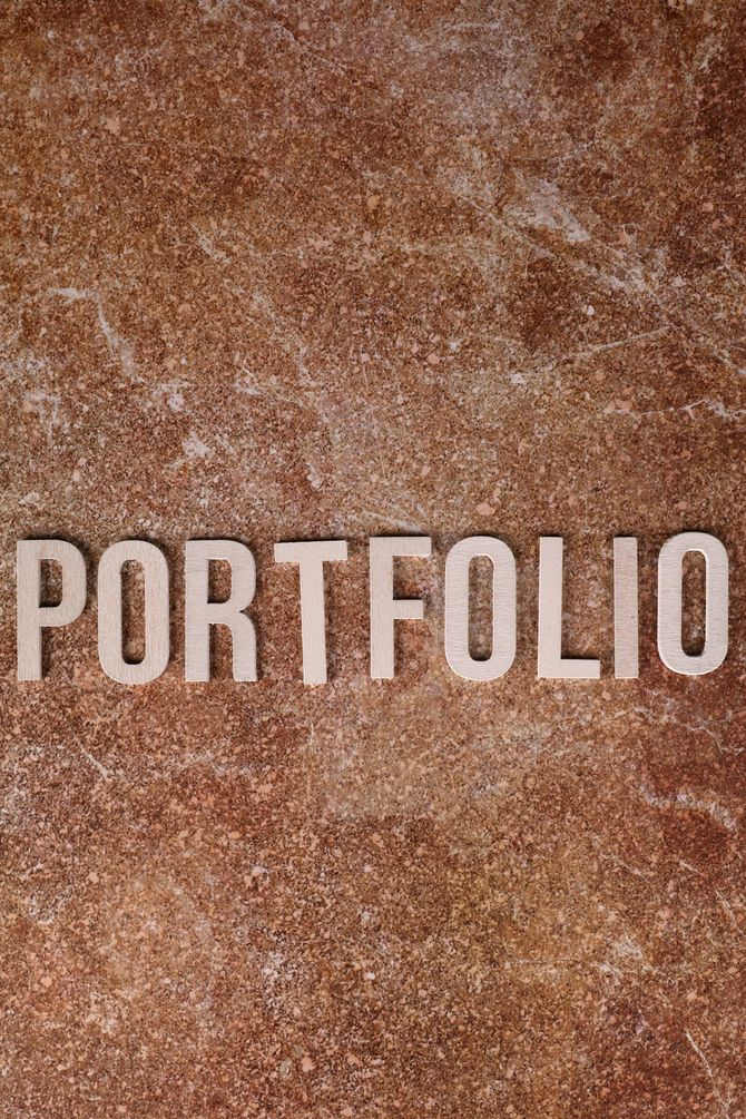 PORTFOLIO in large white letters on a brown textured background