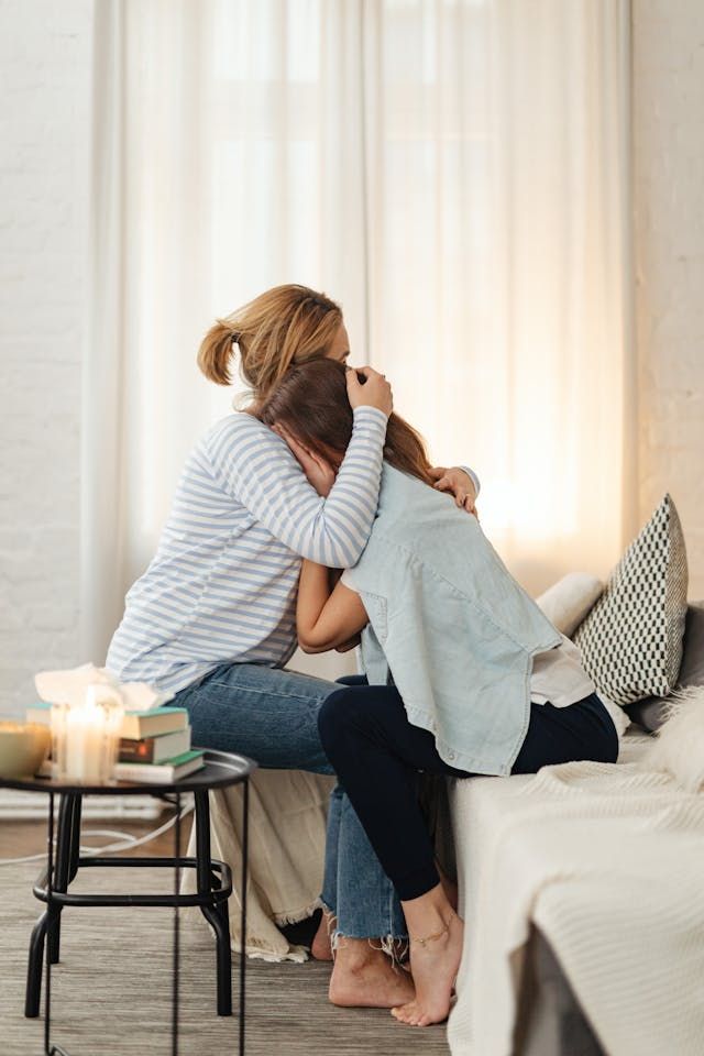 A mother and daughter grieving from the loss of a loved one