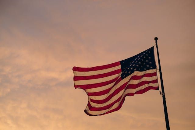 An American flag waving against a warm evening sky adds a respectful touch to Roanoke, VA cremations