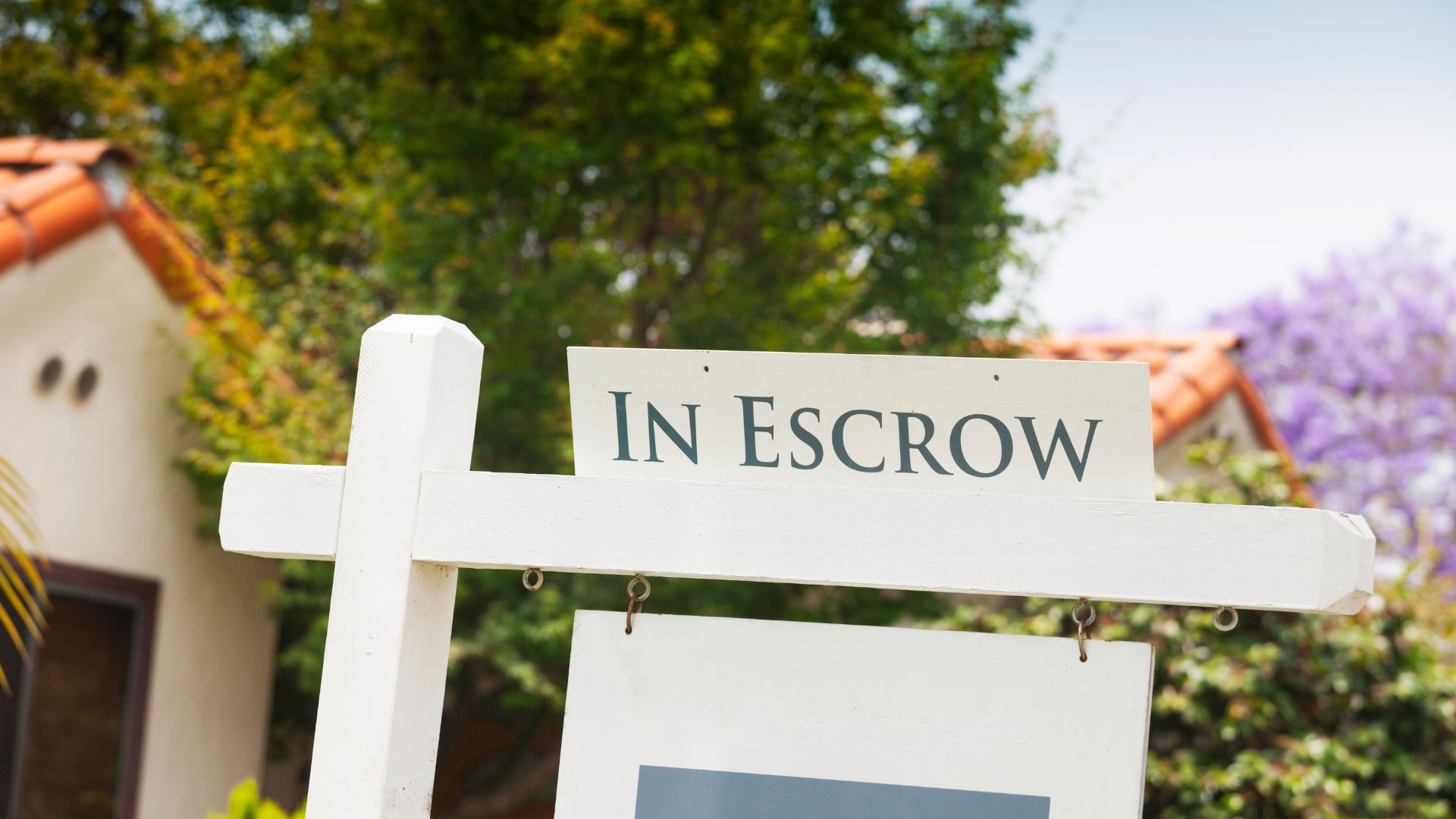 A white real estate sign with the words