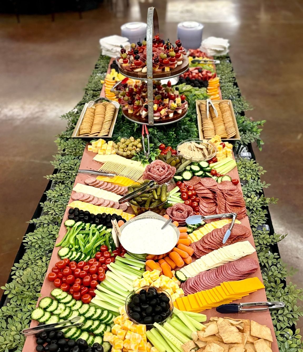 A long buffet table filled with lots of food and vegetables.