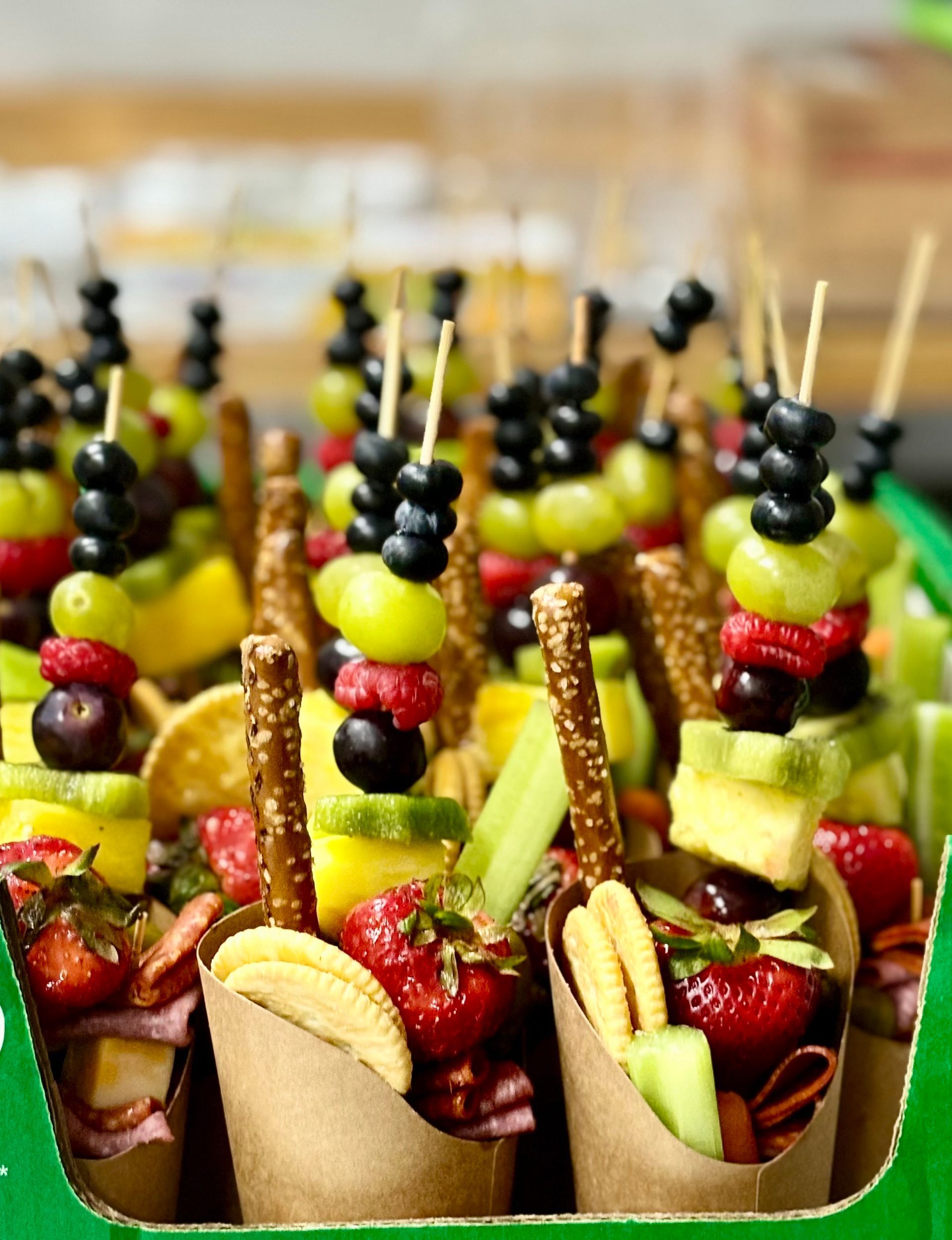 Cardboard cones filled with fruit and pretzels on sticks