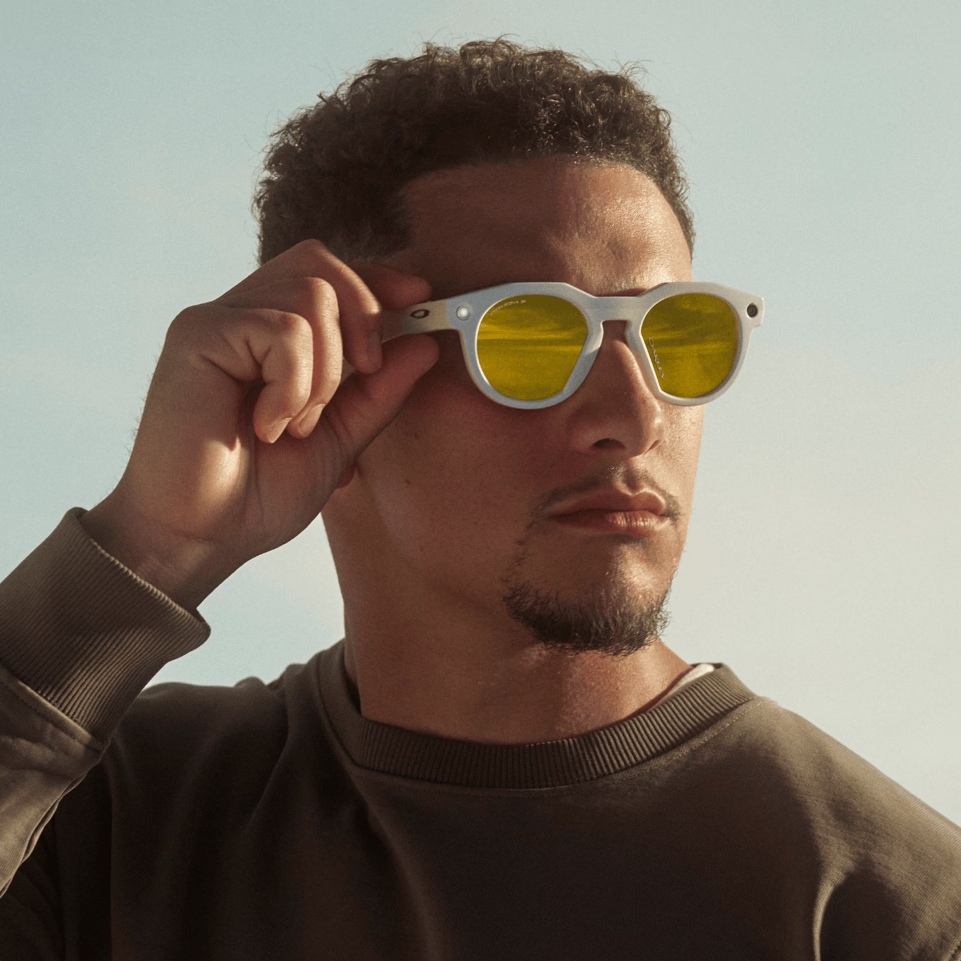 A man wearing white sunglasses with yellow lenses