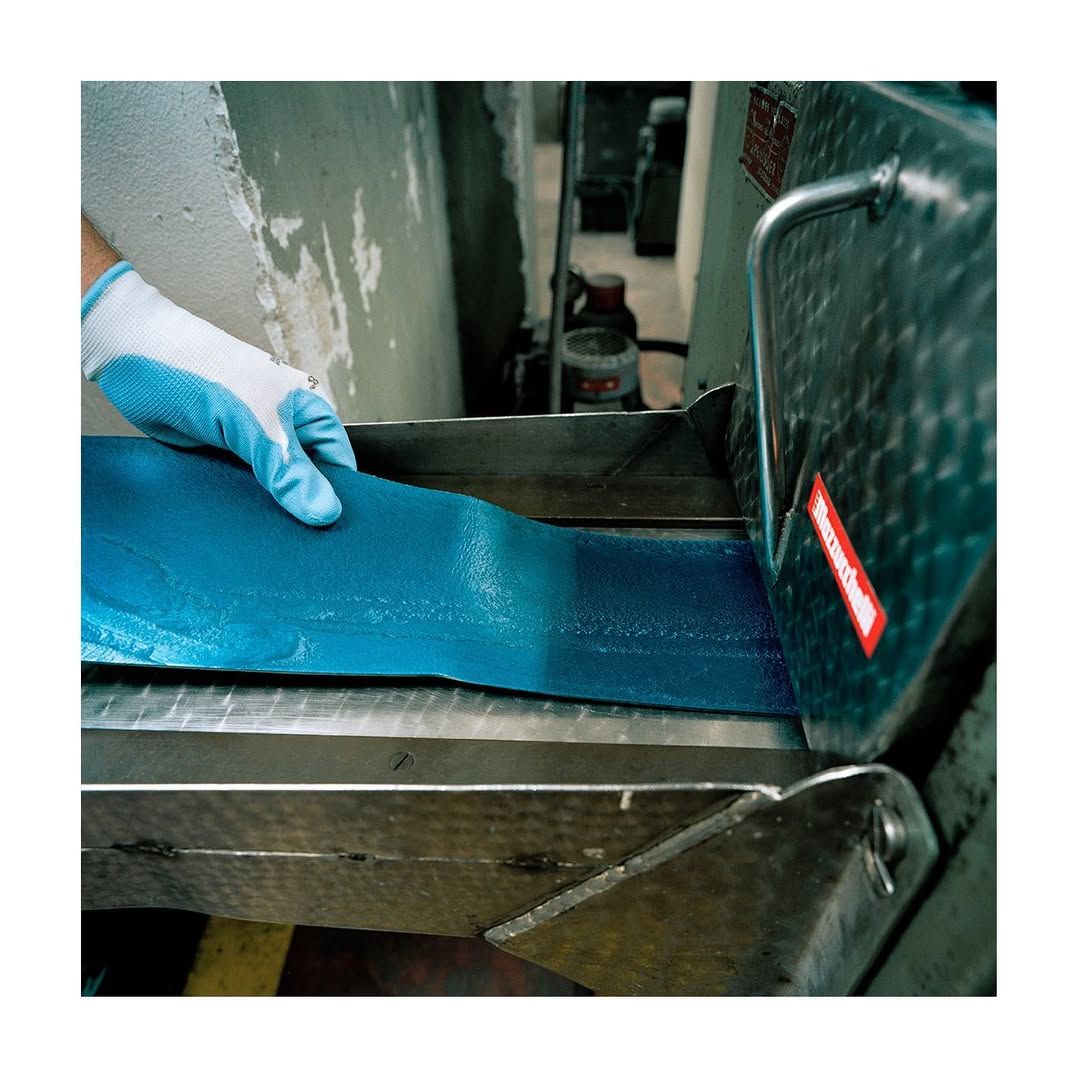 Blue sheet of acetate being pulled.