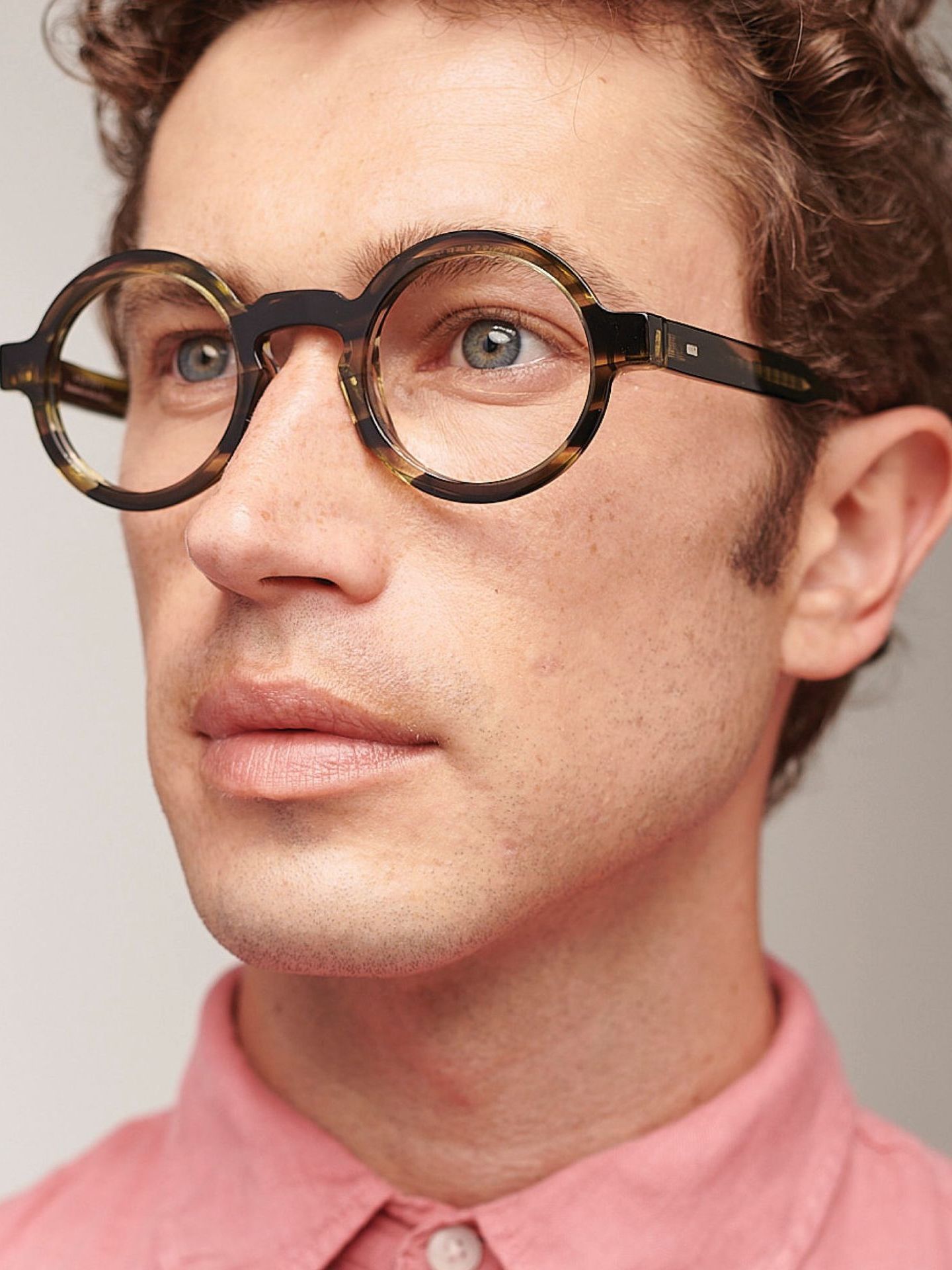 A close up of a man wearing glasses.