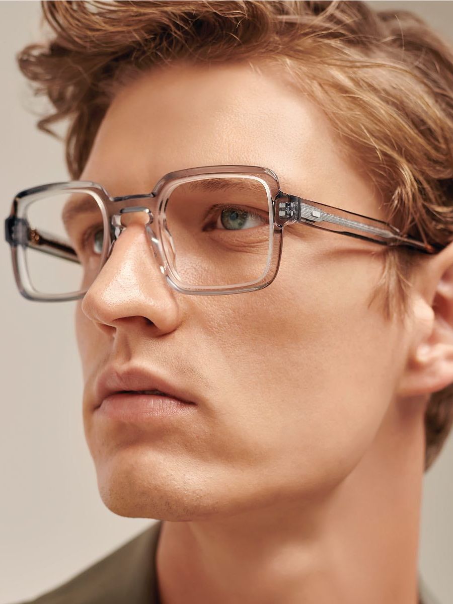 A close up of a man wearing glasses.