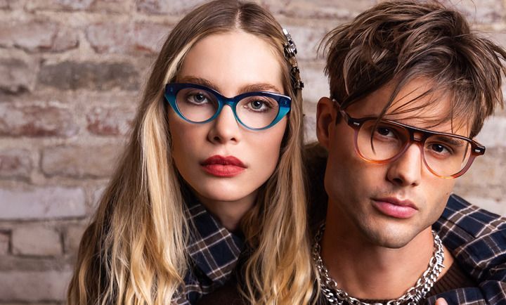 A man and a woman wearing glasses are posing for a picture.