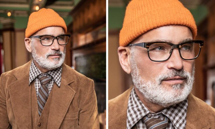 A man with a beard wearing glasses and an orange beanie.