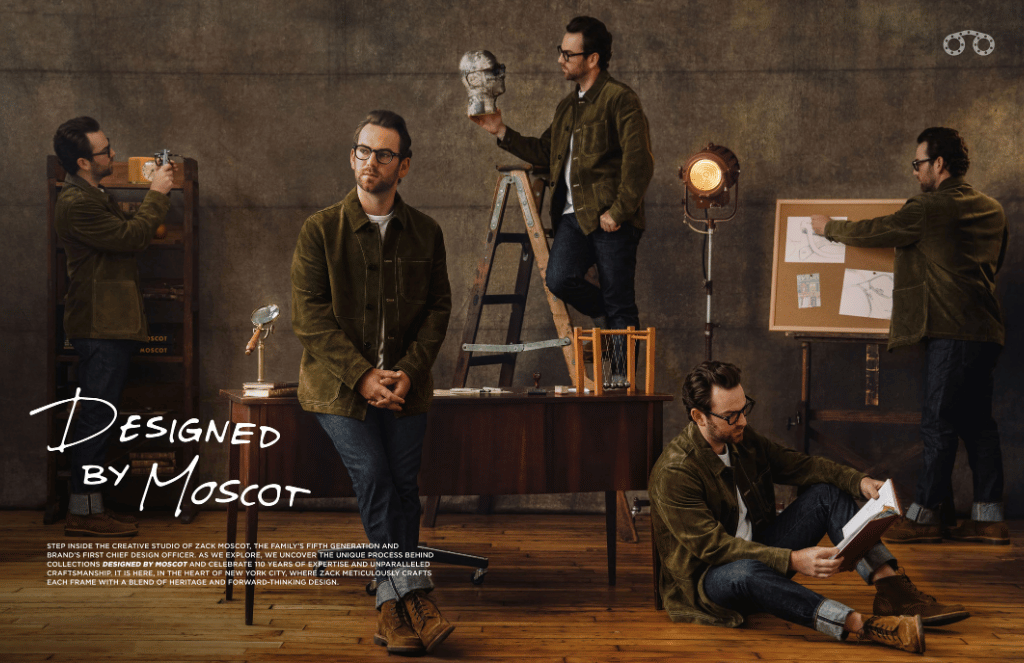Zack Moscot in a green jacket is sitting on a wooden table.