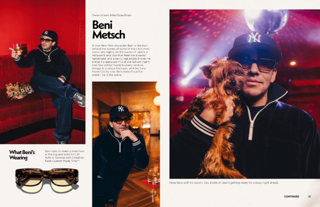 Beni Metsch, in a black cap and sunglasses, poses. Holding a small dog. Red and gold backdrops.