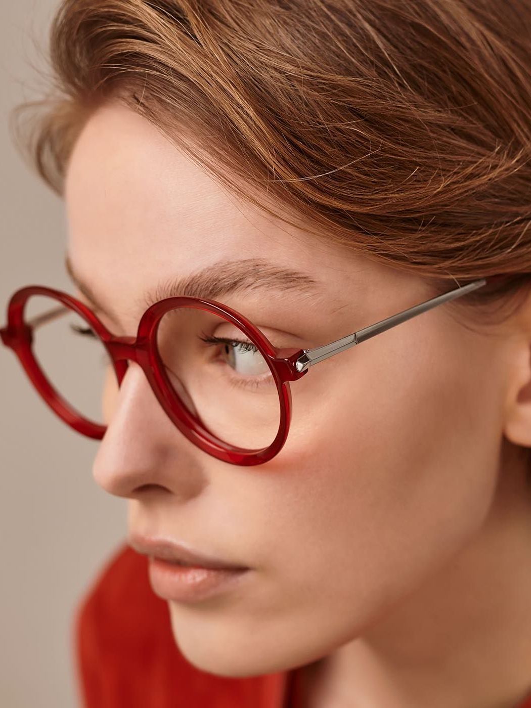 A close up of a woman wearing red glasses