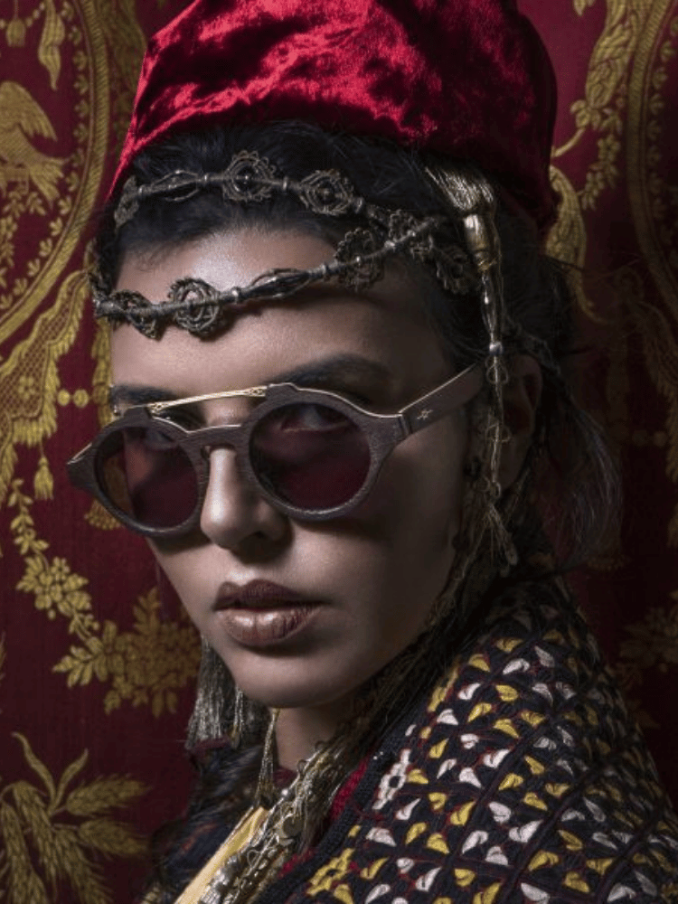A woman wearing sunglasses and a red hat