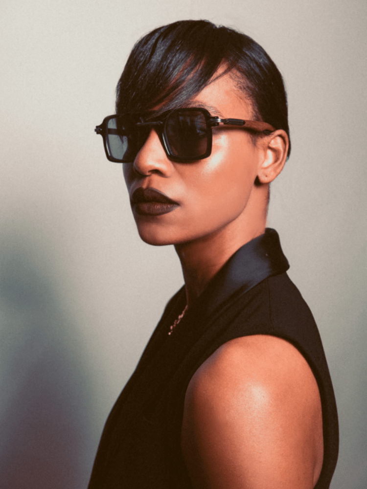 A woman wearing sunglasses and a black shirt