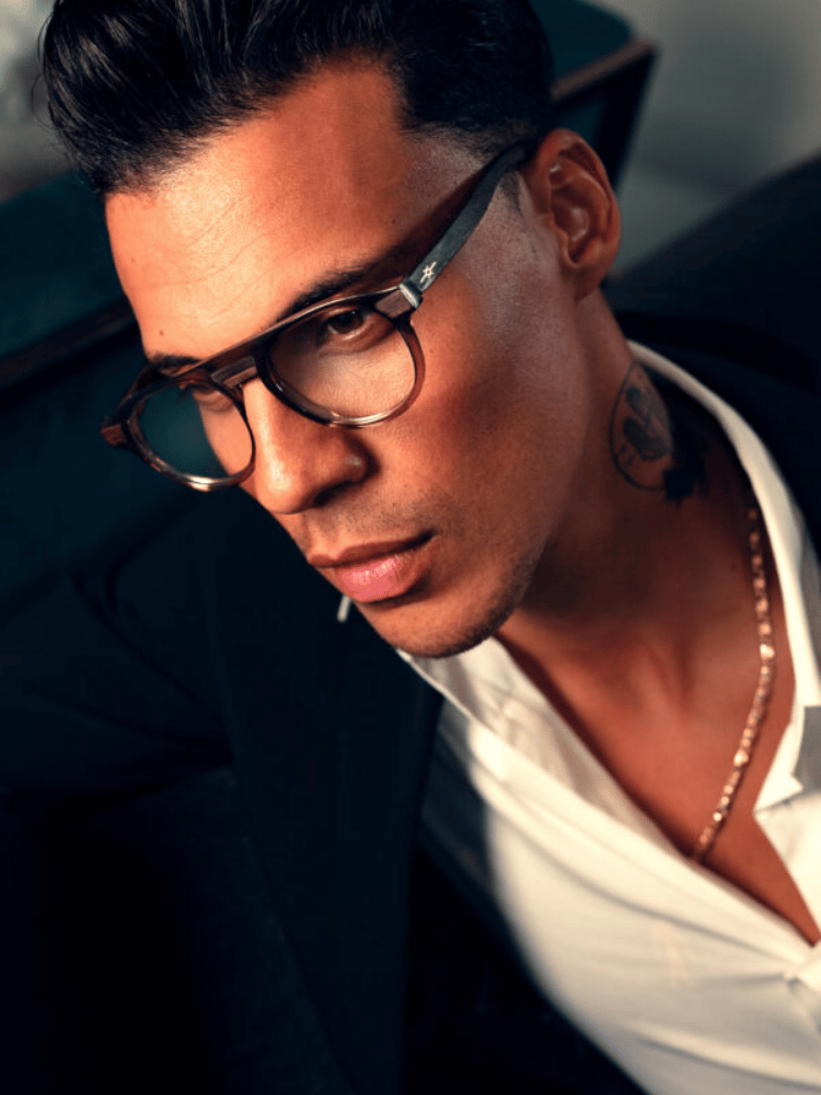 A close up of a man wearing glasses and a white shirt
