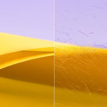 An optical lens, one side clear the other side full of scratches.