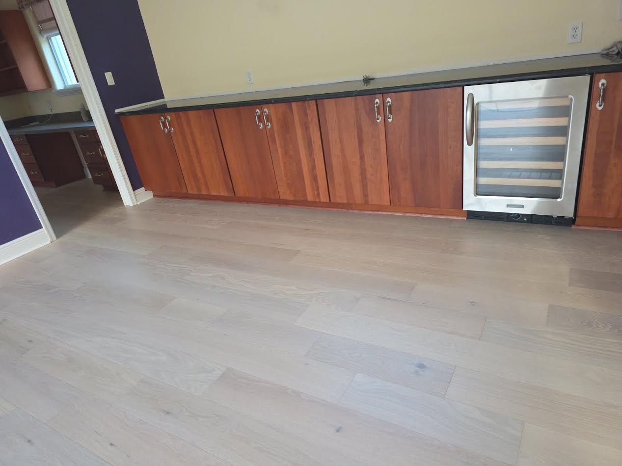 Kitchen with wood cabinets, light flooring, and a stainless beverage cooler on the right