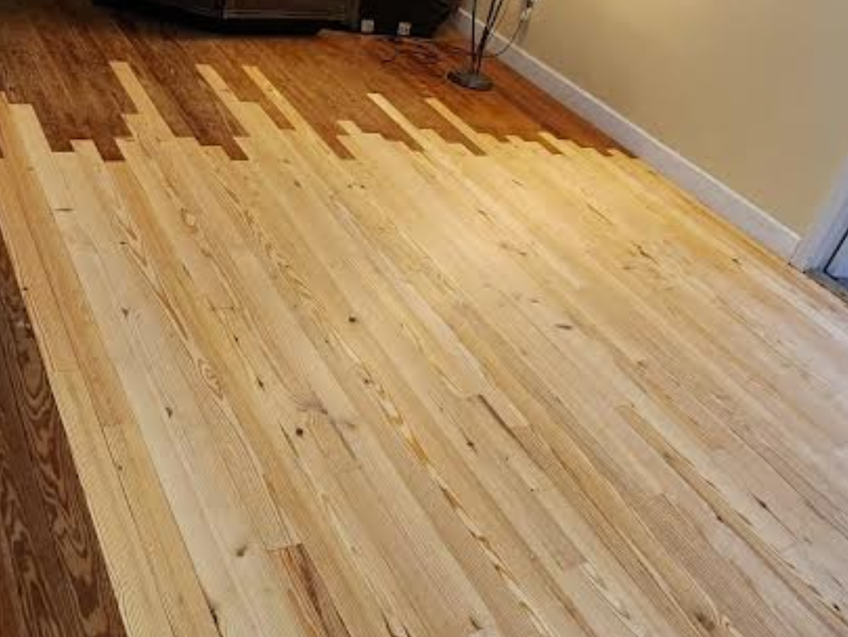 Shiny hardwood hallway with a striped rug and sunlight casting shadows through windows