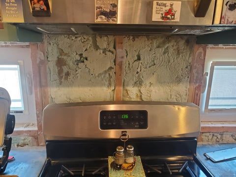 A stainless steel stove top oven is sitting on top of a kitchen counter.