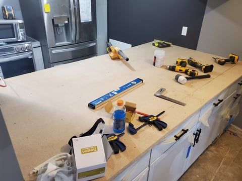 A kitchen counter with a lot of tools on it.