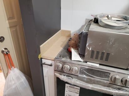 A microwave oven is sitting on top of a stove in a kitchen.