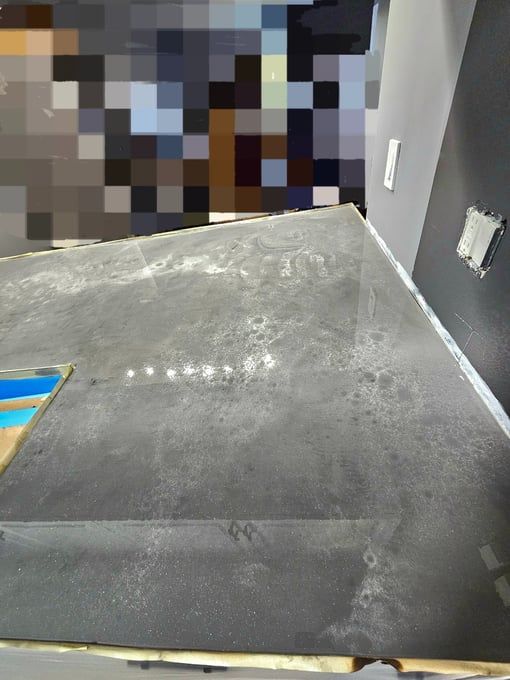 A concrete floor is being installed in a room.