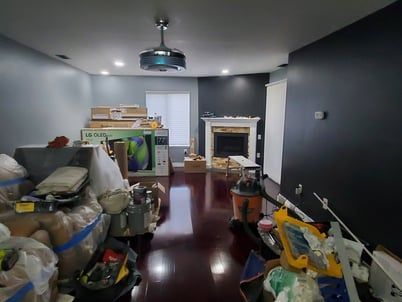 A living room filled with lots of boxes and a fireplace.