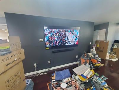 A living room with a flat screen tv hanging on the wall.