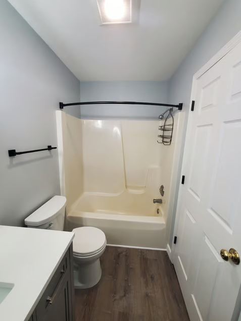 A bathroom with a toilet a sink and a bathtub